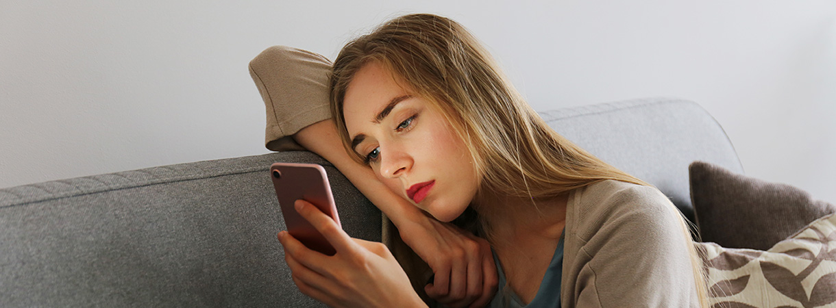 psicologo-online-compararte-con-los-demas-redes-sociales-autoestima.jpg Persona mirando el móvil con expresión decaída, representando el efecto de compararse constantemente con los demás en redes sociales